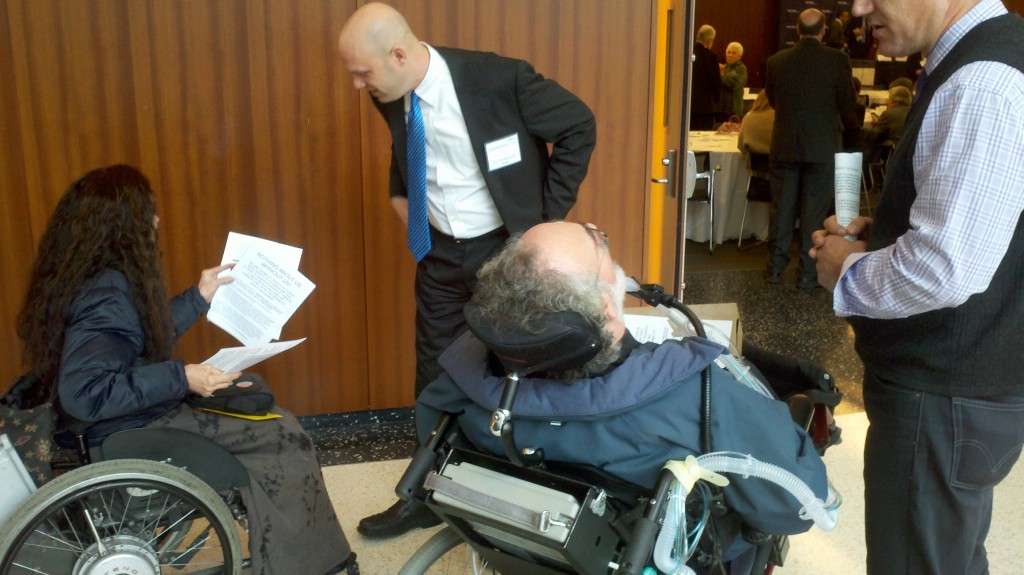 Nadina Laspina at left talks to Thaddeus Pope while Danny Robert - facing away - talks to unknown symposium participant