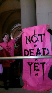 Albany 5-10-16 Not Dead Yet activists wearing pink NDY tshirts & holding pink NDY banner