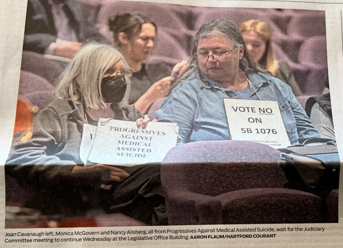 Photo of PAMAS members with signs opposing assisted suicide bill. Credit Aaron Flaum/Hartford Courant