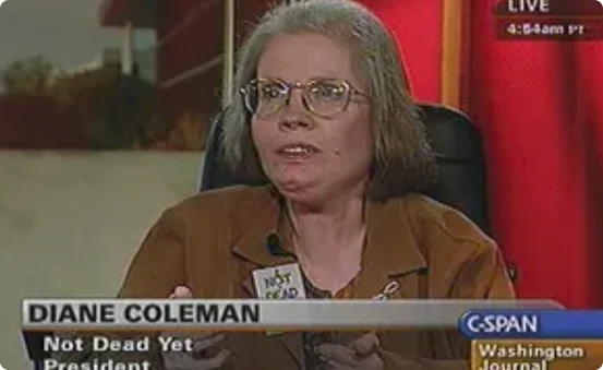 Diane Coleman, a white woman in glasses and a brown blazer, on the channel C-SPAN. The C-SPAN subtitle underneath her says "Diane Coleman - Not Dead Yet - President."
